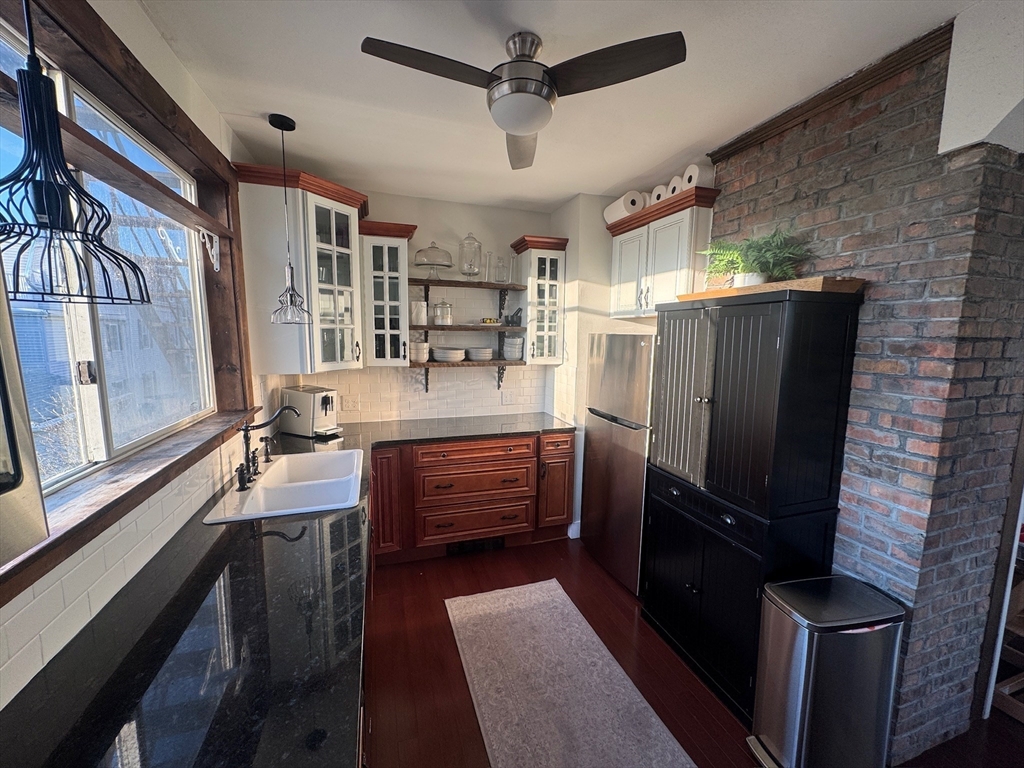 38 Pinckney Street, Unit 3 Somerville, MA 02145 - Photo 4 of 40 a kitchen with granite countertop a refrigerator stove and sink