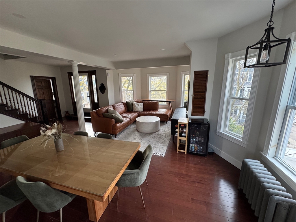 38 Pinckney Street, Unit 3 Somerville, MA 02145 - Photo 9 of 40 a living room with furniture two window and wooden floor