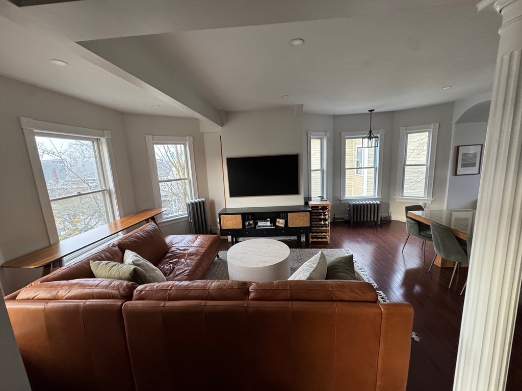 38 Pinckney Street, Unit 3 Somerville, MA 02145 - Photo 10 of 40 a living room with furniture and a flat screen tv