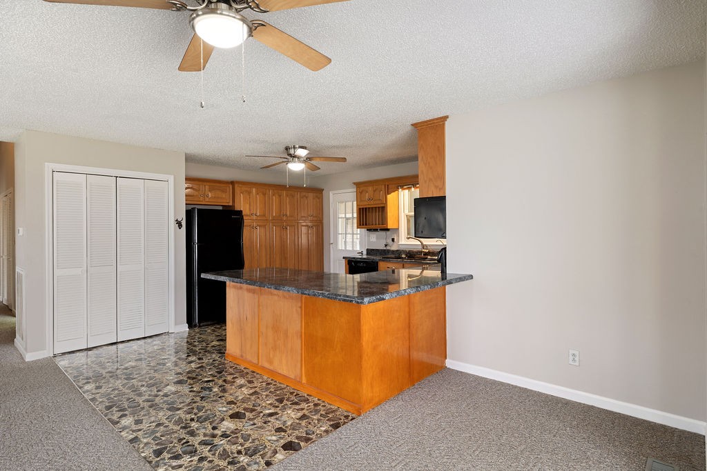 210 Salem Road Minor Hill, TN 38473 - Photo 12 of 27 a kitchen with stainless steel appliances granite countertop a sink and a refrigerator