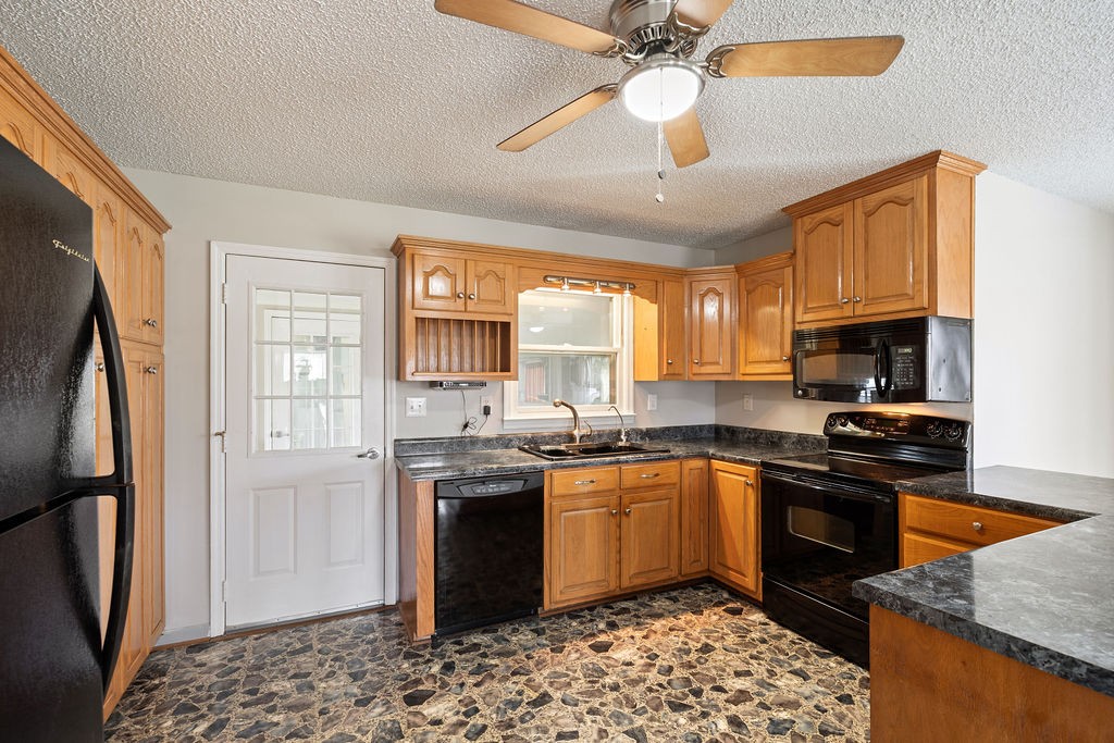 210 Salem Road Minor Hill, TN 38473 - Photo 13 of 27 a kitchen with stainless steel appliances granite countertop a sink stove and refrigerator