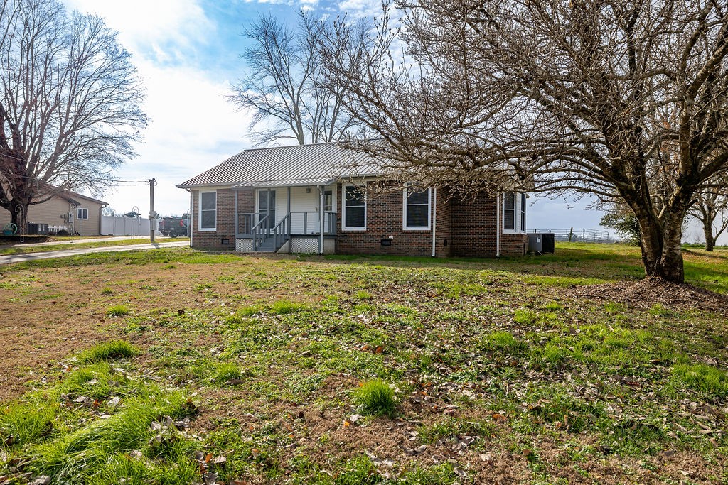 210 Salem Road Minor Hill, TN 38473 - Photo 3 of 27 a view of a house with a large tree and a big yard