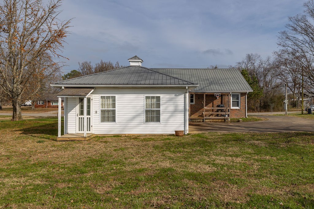 210 Salem Road Minor Hill, TN 38473 - Photo 5 of 27 a front view of a house with a garden