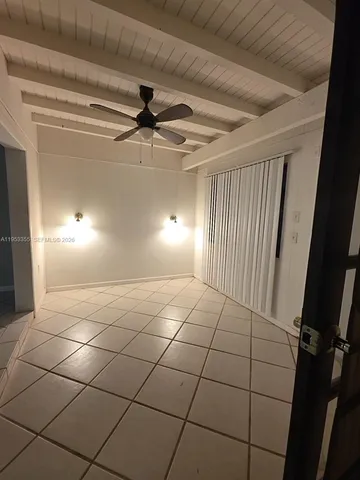 a view of a livingroom with a ceiling fan and window