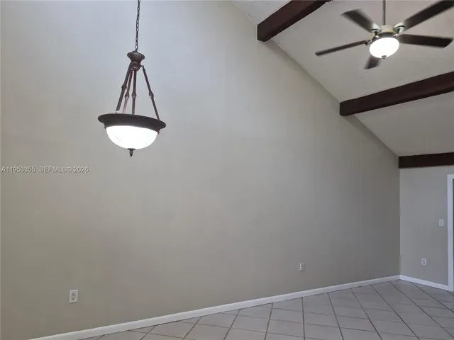 a view of a room with a fan and a ceiling fan
