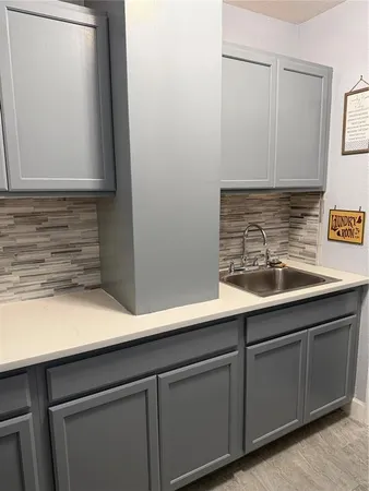 a kitchen with stainless steel appliances kitchen island granite countertop a table chairs and a refrigerator