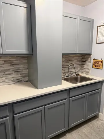 a kitchen with stainless steel appliances kitchen island granite countertop a table chairs and a refrigerator