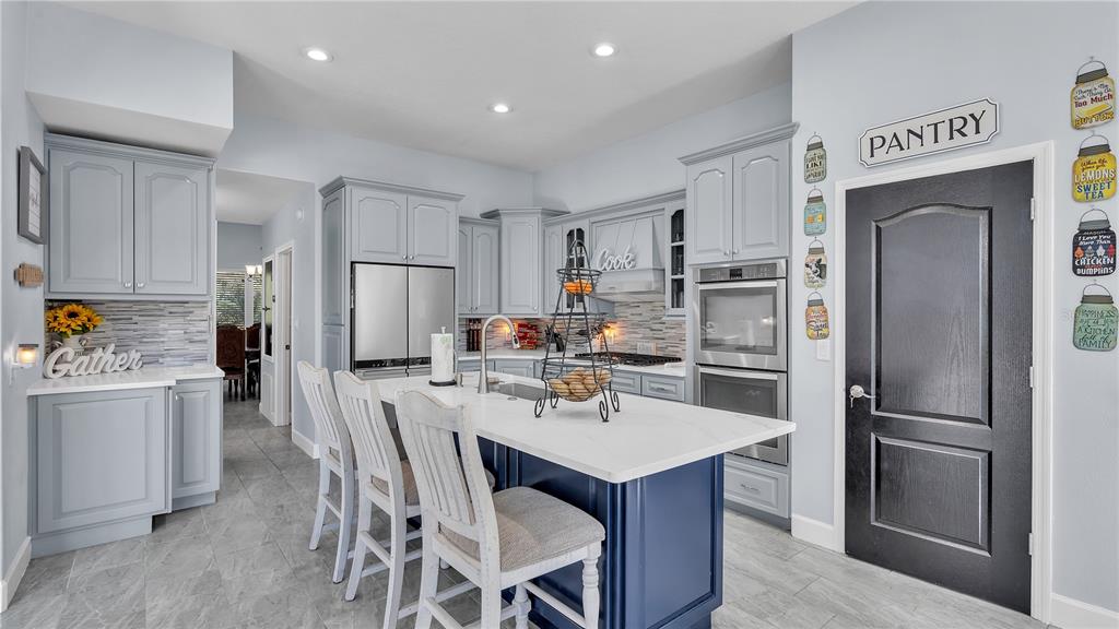 3943 West Campbell Road Lakeland, FL 33810 - Photo 13 of 71 a kitchen with refrigerator a sink and chairs