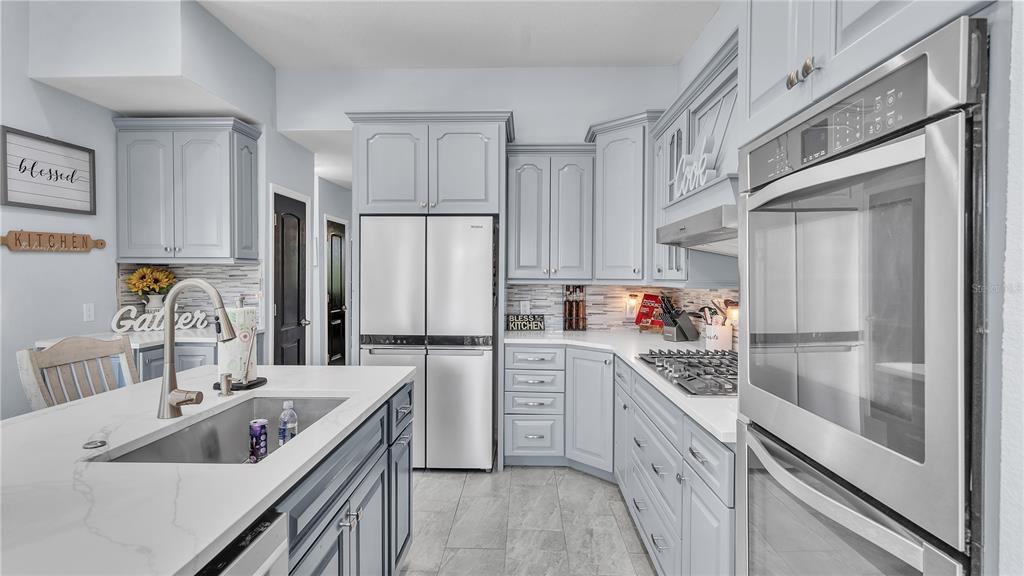 3943 West Campbell Road Lakeland, FL 33810 - Photo 15 of 71 a kitchen with a sink stove and refrigerator