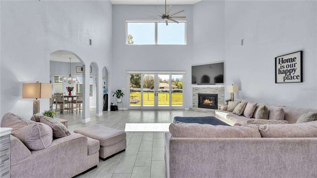 3943 West Campbell Road Lakeland, FL 33810 - Photo 23 of 71 a living room with furniture a fireplace and a flat screen tv