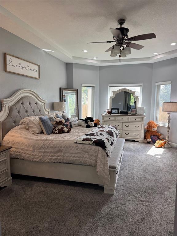 3943 West Campbell Road Lakeland, FL 33810 - Photo 28 of 71 a spacious bedroom with a bed a couch and a chandelier