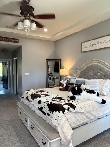 a bedroom with a bed and a refrigerator