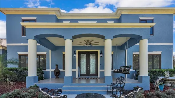 a front view of a house with outdoor seating