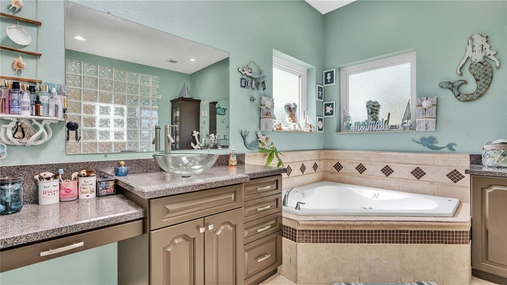 3943 West Campbell Road Lakeland, FL 33810 - Photo 31 of 71 a bathroom with a sink and a mirror