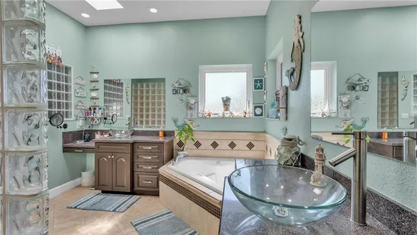 a bathroom with a granite countertop sink a toilet and a mirror