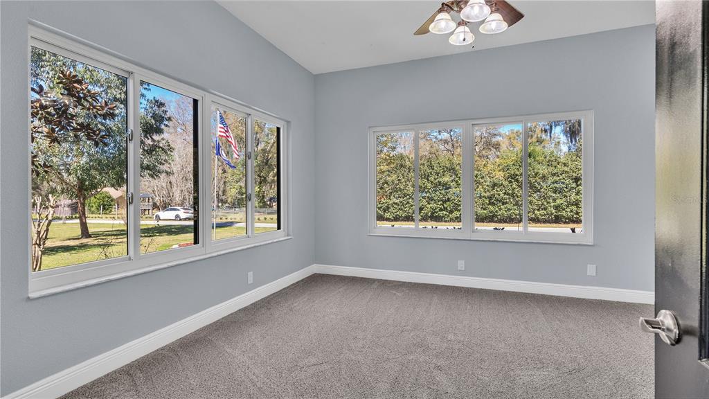 3943 West Campbell Road Lakeland, FL 33810 - Photo 38 of 71 a view of a big room with windows and chandelier fan
