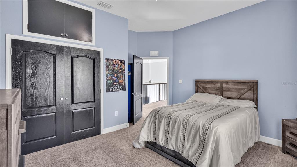 3943 West Campbell Road Lakeland, FL 33810 - Photo 44 of 71 a bedroom with a bed and a refrigerator