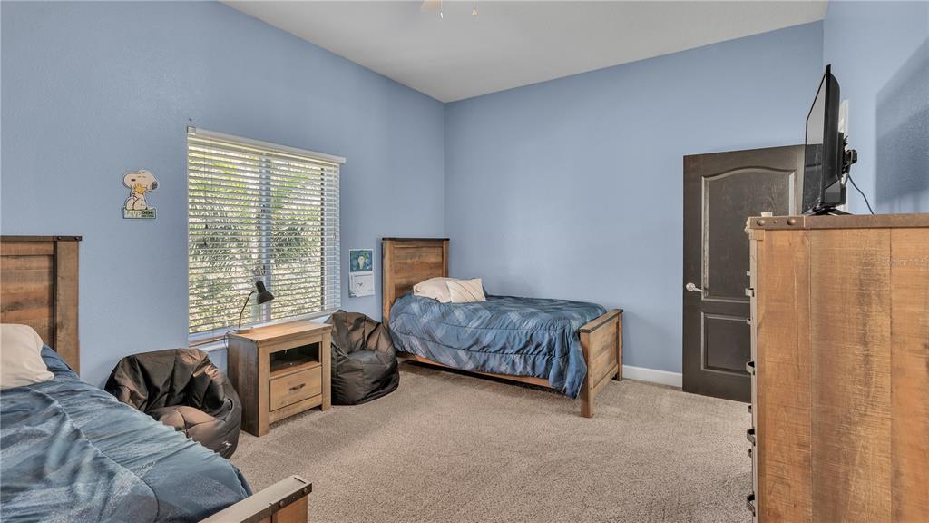 3943 West Campbell Road Lakeland, FL 33810 - Photo 53 of 71 a bedroom with furniture and a flat screen tv