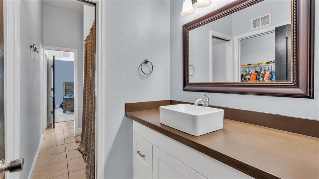 3943 West Campbell Road Lakeland, FL 33810 - Photo 55 of 71 a bathroom with a sink and two mirror