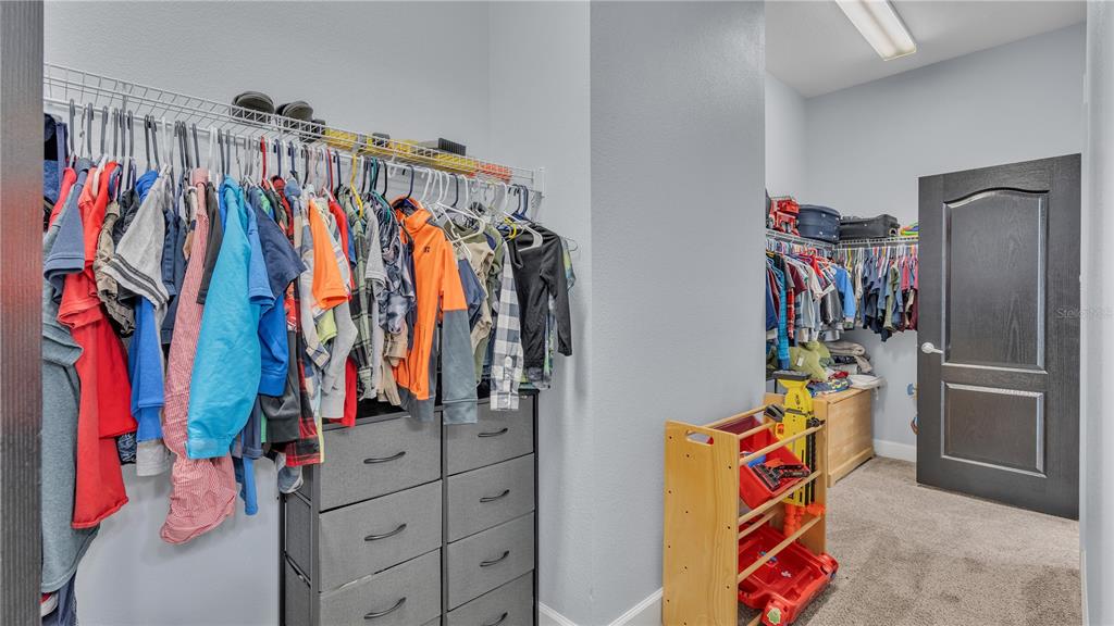 3943 West Campbell Road Lakeland, FL 33810 - Photo 56 of 71 a view of walk in closet with clothes