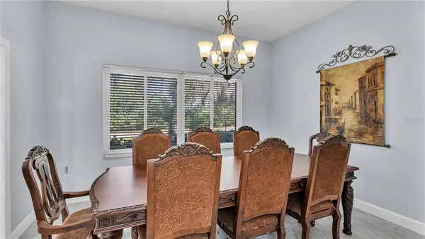 a kitchen with refrigerator a sink and chairs