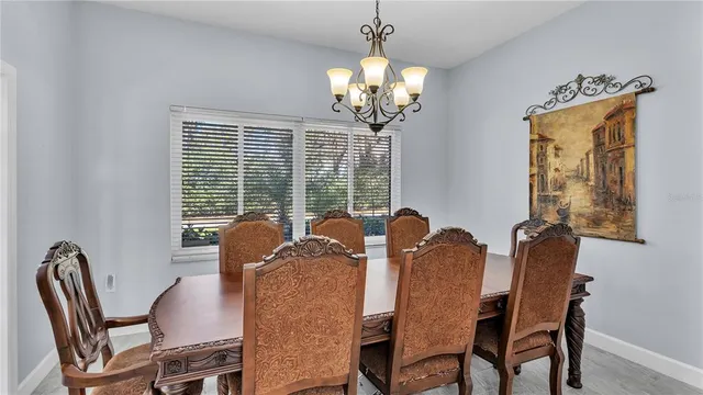 a kitchen with refrigerator a sink and chairs