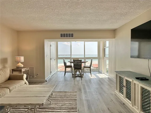 a living room with a couch and wooden floor