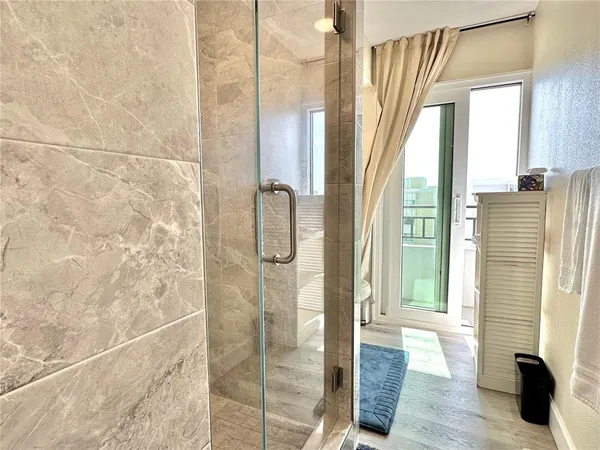 a bathroom with a granite countertop sink toilet and mirror