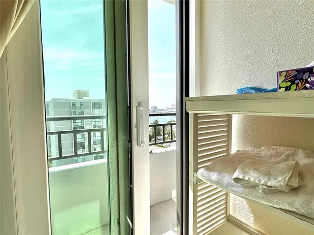 a view of a bedroom with a bed and wooden floor