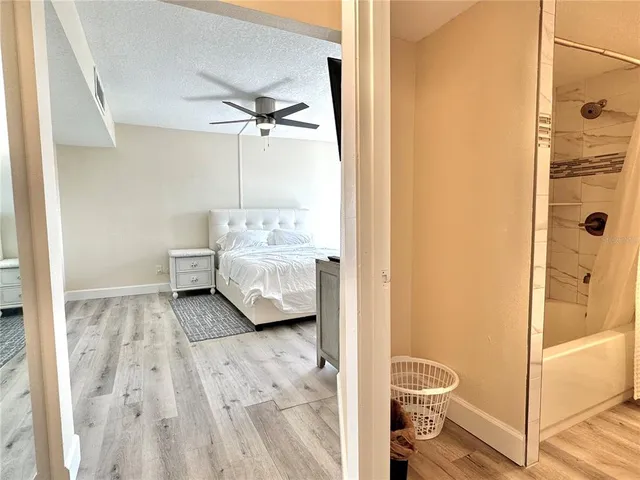 a large bed sitting in a bedroom next to a window