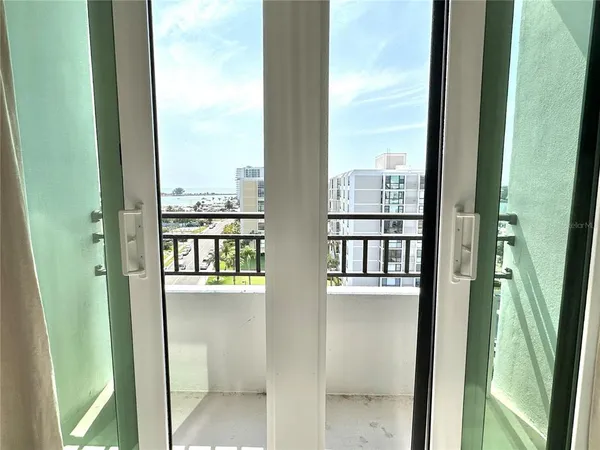 a view of a balcony with wooden stairs and outdoor seating