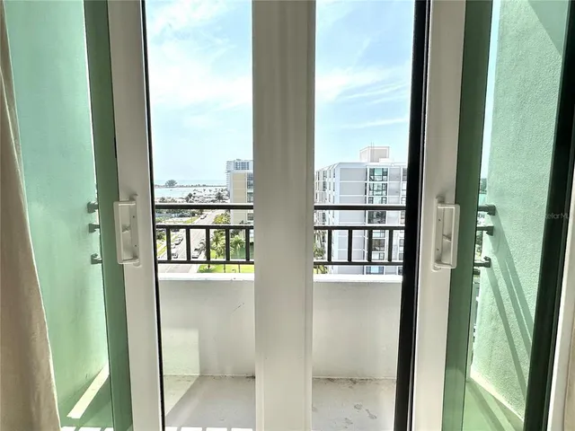 a view of a balcony with wooden stairs and outdoor seating