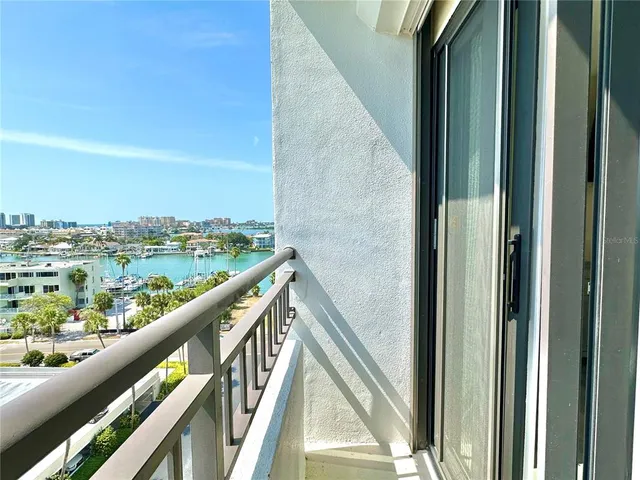 a view of a swimming pool with a table and chairs potted plants