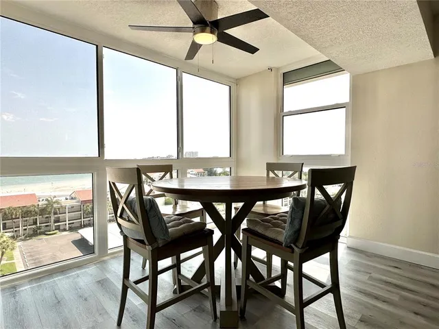 a kitchen with granite countertop a stove sink and refrigerator