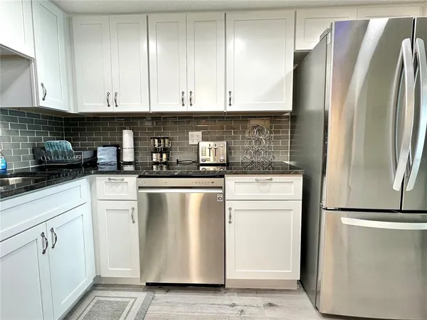 a kitchen with white cabinets and a sink