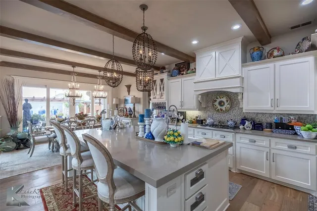 a kitchen with sink cabinets and wooden floor
