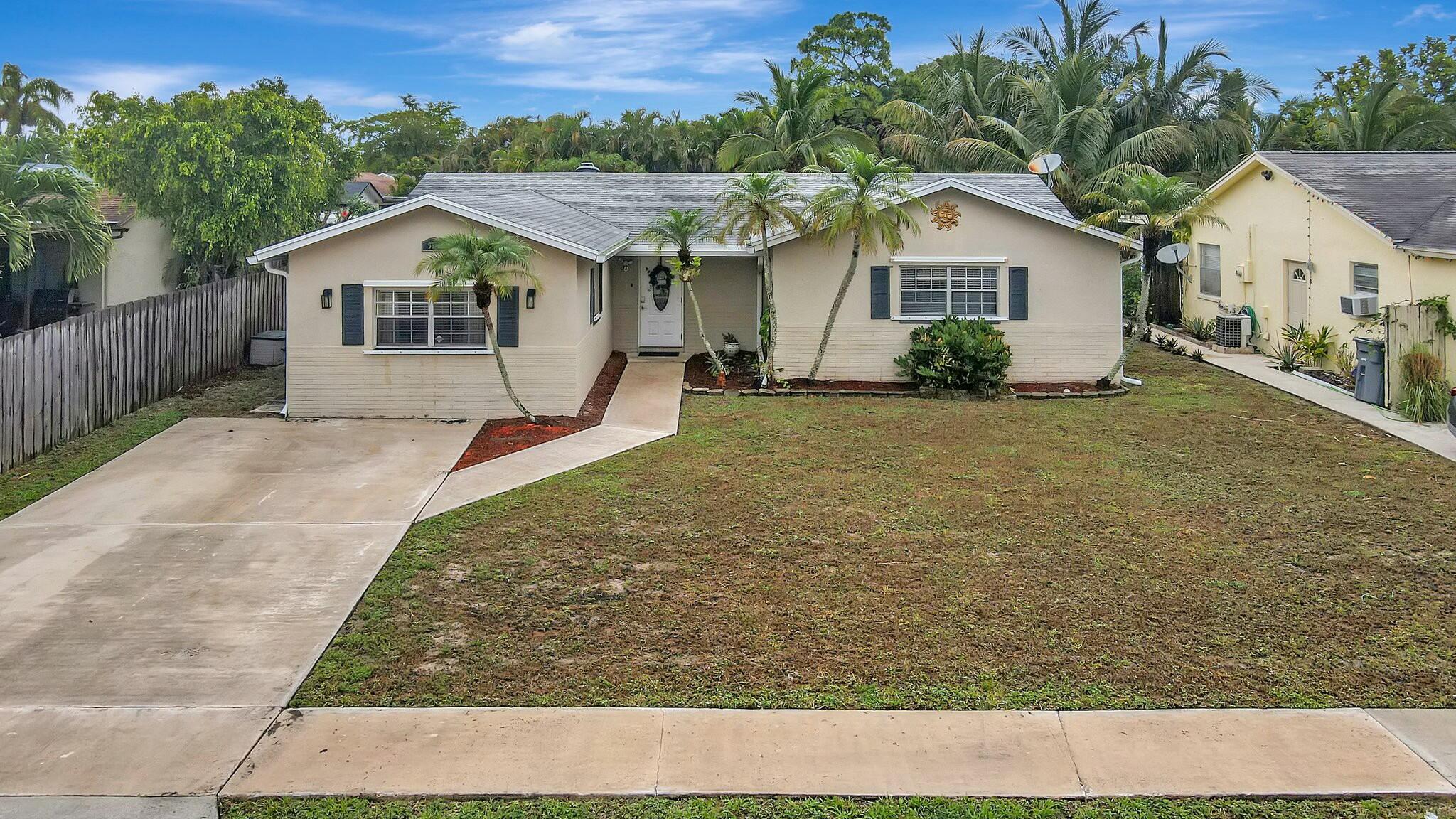 9033 Southwest 6th Street Boca Raton, FL 33433 - Photo 51 of 56 front view of a house with a yard