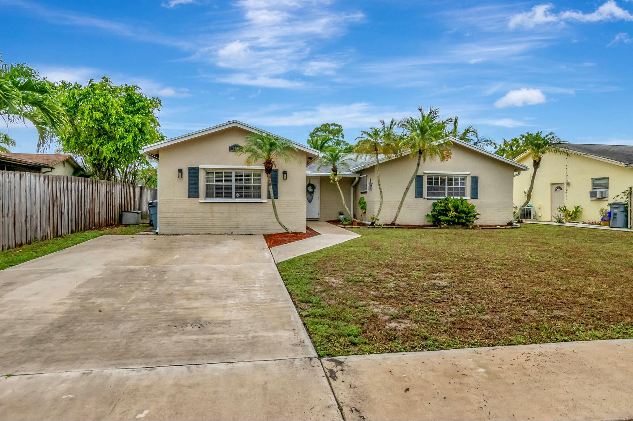 9033 Southwest 6th Street Boca Raton, FL 33433 - Photo 53 of 56 a front view of a house with a garden and plants