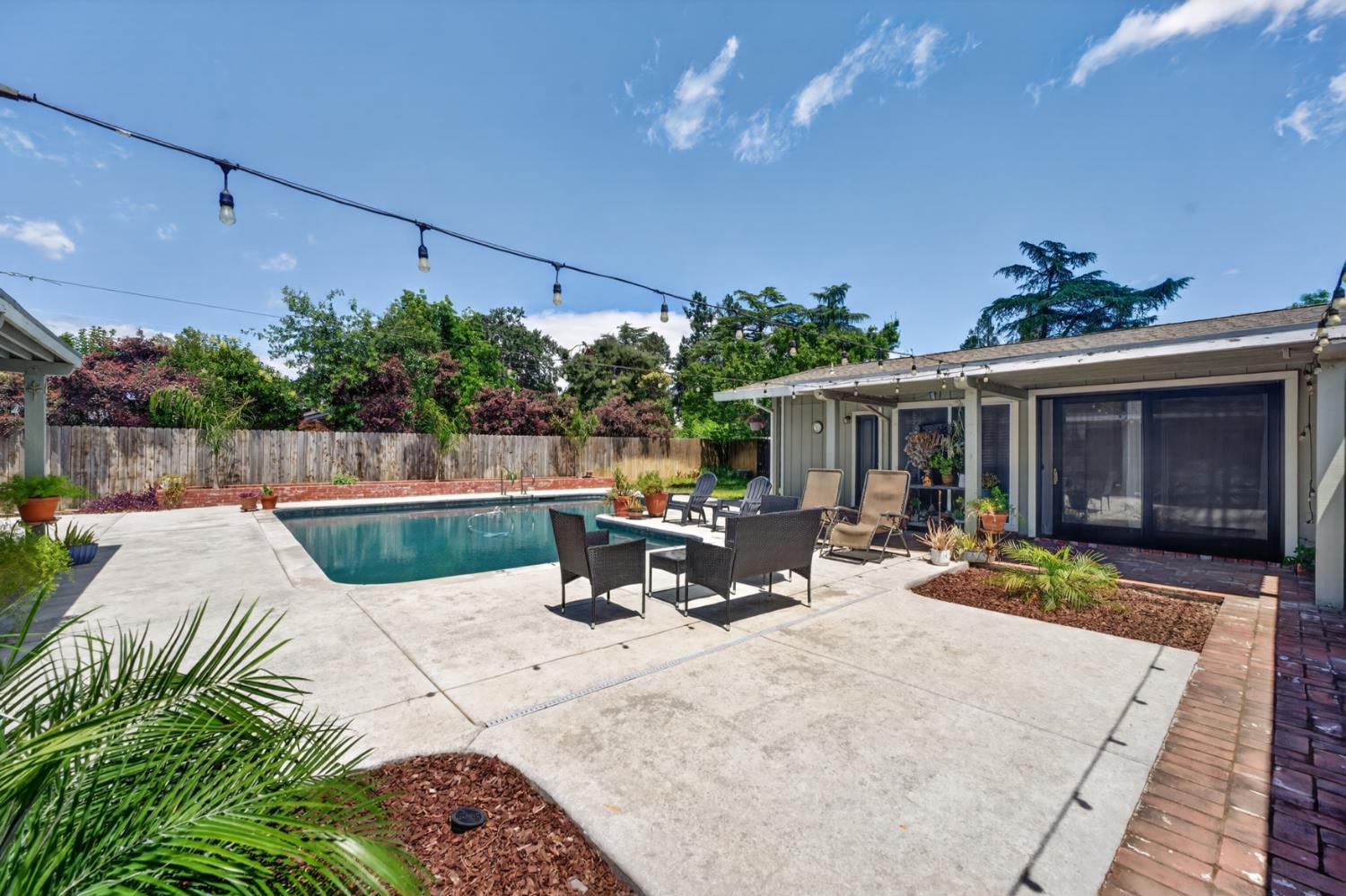 1880 Magnolia Street Gridley, CA 95948 - Photo 53 of 95 a view of a patio with table and chairs potted plants with wooden floor