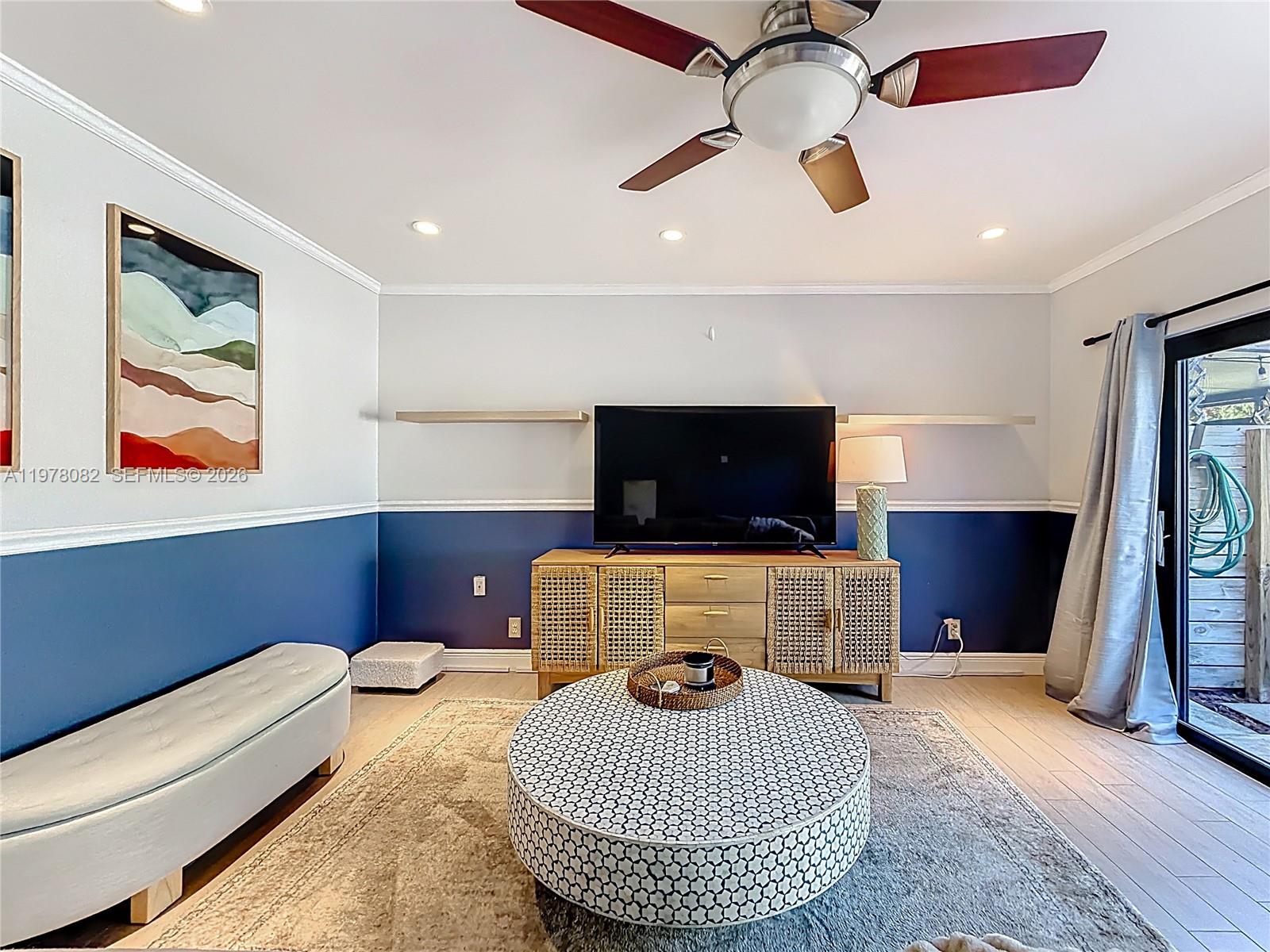 2128 Northeast 9th Avenue Wilton Manors, FL 33305 - Photo 11 of 34 a living room with furniture and a flat screen tv