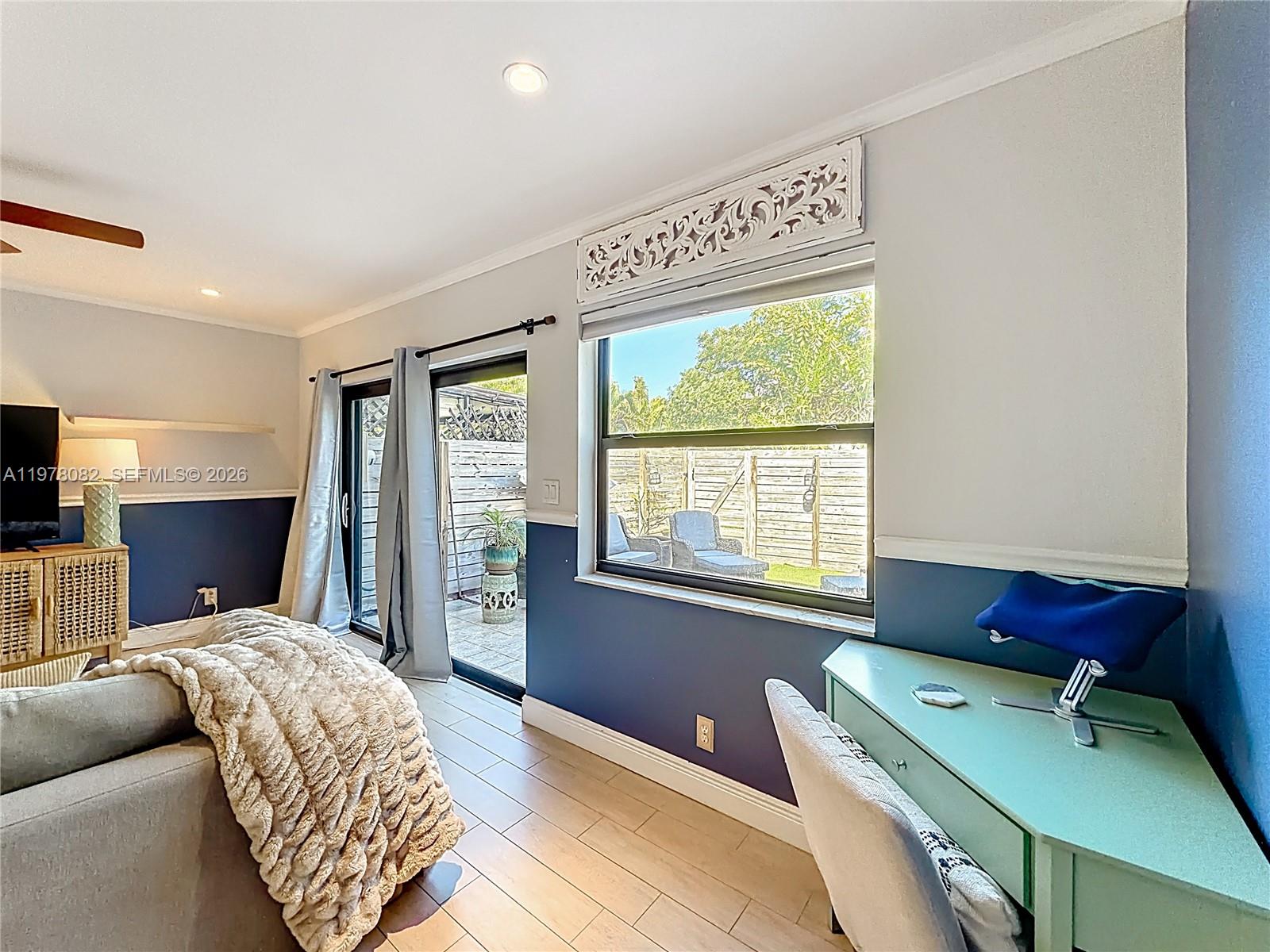 2128 Northeast 9th Avenue Wilton Manors, FL 33305 - Photo 12 of 34 a bedroom with a bed and a window