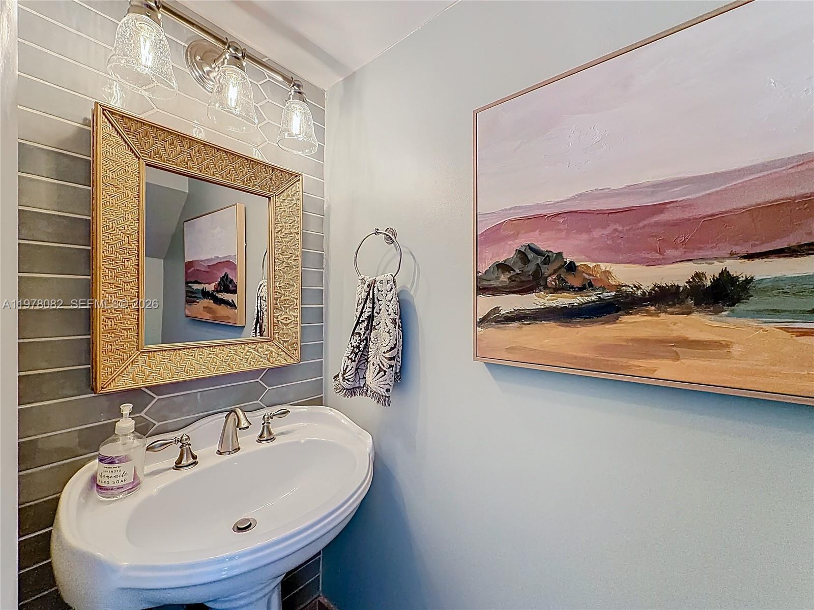 2128 Northeast 9th Avenue Wilton Manors, FL 33305 - Photo 15 of 34 a bathroom with a sink and a mirror