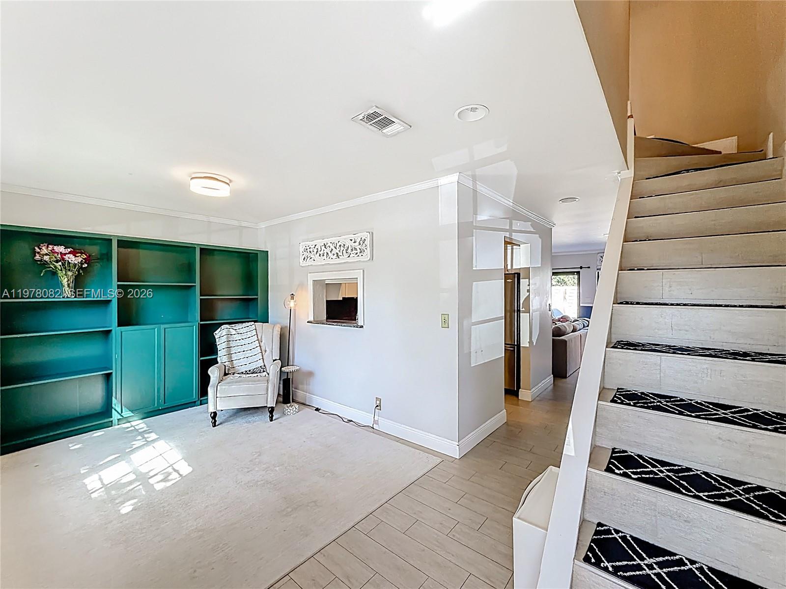 2128 Northeast 9th Avenue Wilton Manors, FL 33305 - Photo 16 of 34 a view of a livingroom with furniture and stairs