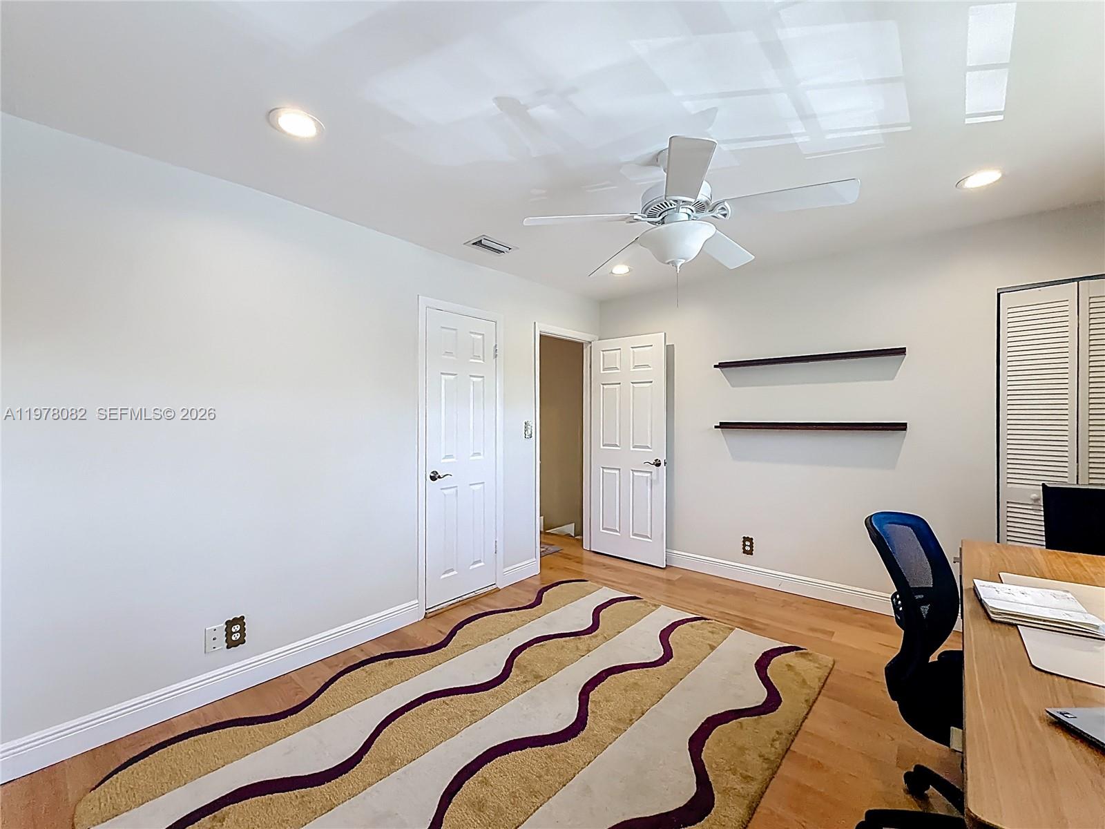 2128 Northeast 9th Avenue Wilton Manors, FL 33305 - Photo 18 of 34 a bedroom with a bed and a chandelier