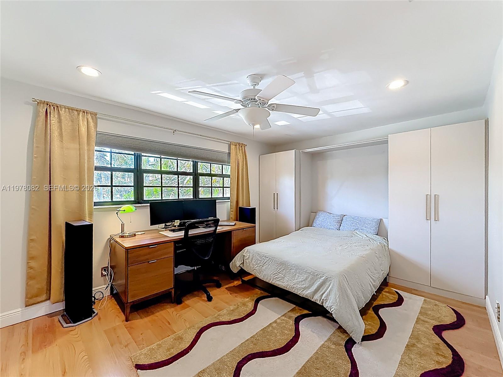 2128 Northeast 9th Avenue Wilton Manors, FL 33305 - Photo 19 of 34 a living room with furniture and a floor to ceiling window