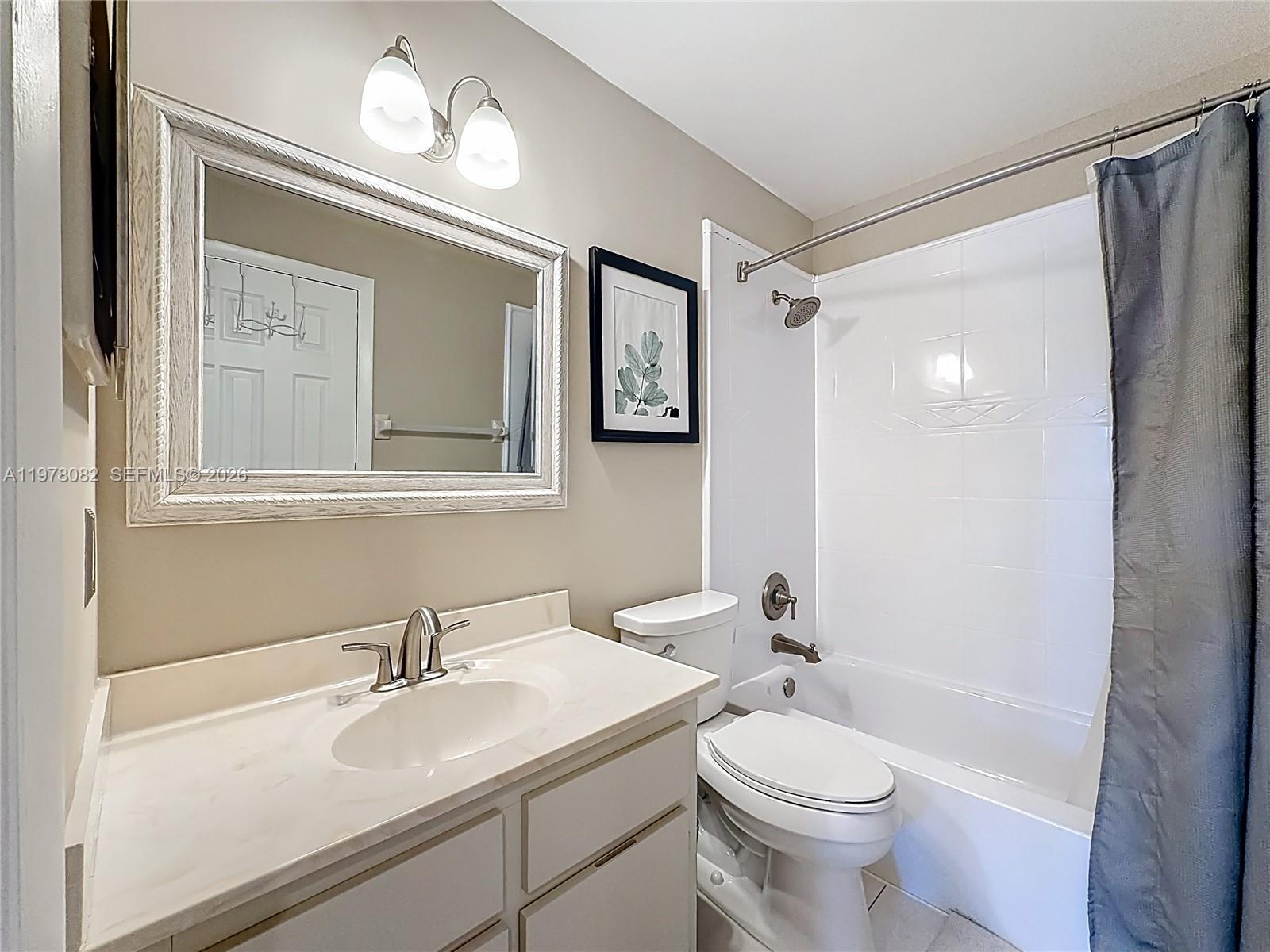 2128 Northeast 9th Avenue Wilton Manors, FL 33305 - Photo 20 of 34 a bathroom with a sink a toilet and shower
