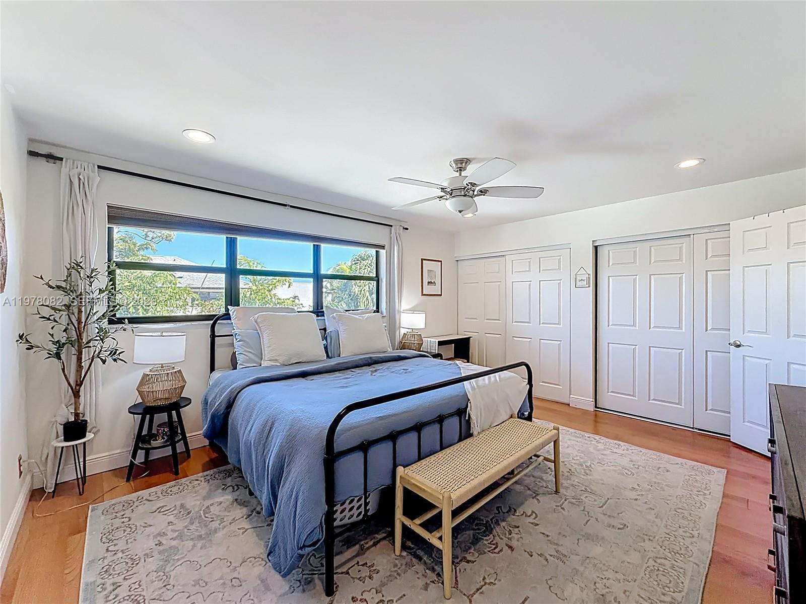 2128 Northeast 9th Avenue Wilton Manors, FL 33305 - Photo 22 of 34 a bed room with a bed and a chandelier