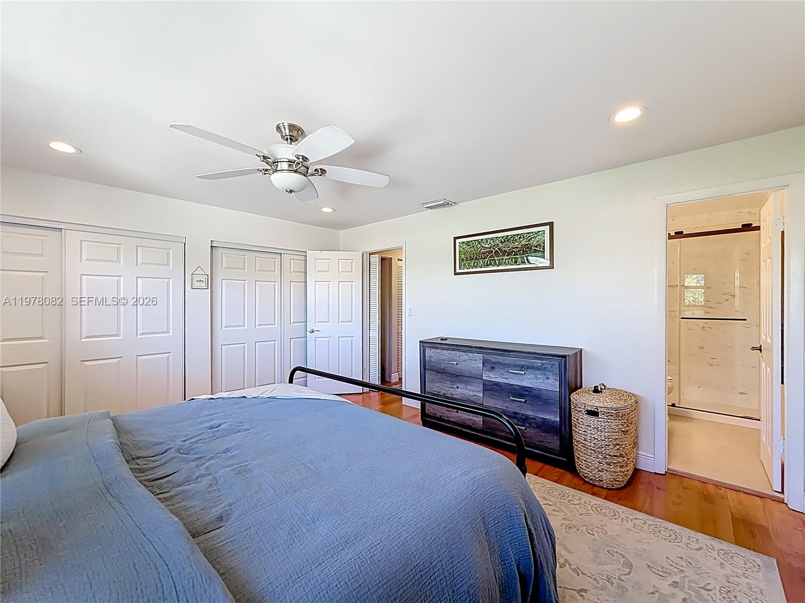 2128 Northeast 9th Avenue Wilton Manors, FL 33305 - Photo 23 of 34 a bedroom with a bed and a chandelier