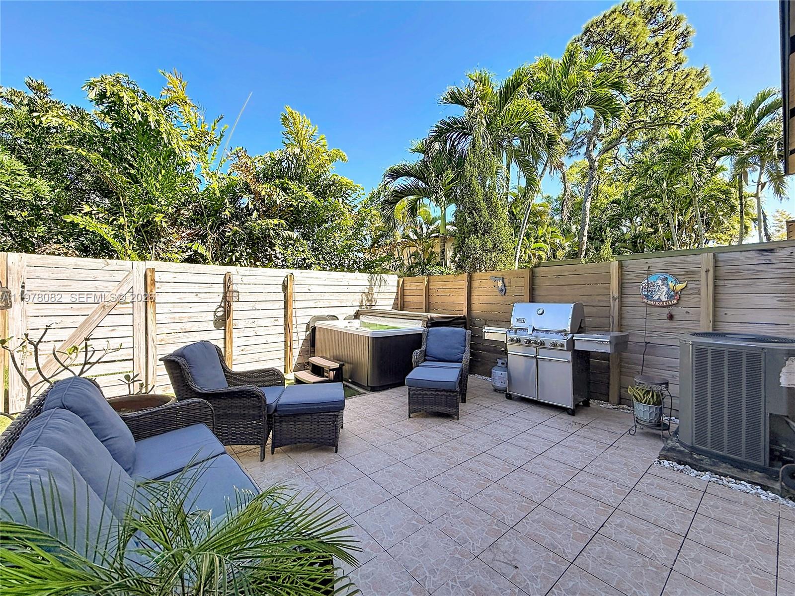 2128 Northeast 9th Avenue Wilton Manors, FL 33305 - Photo 28 of 34 a view of a patio with couches chairs and a potted plant