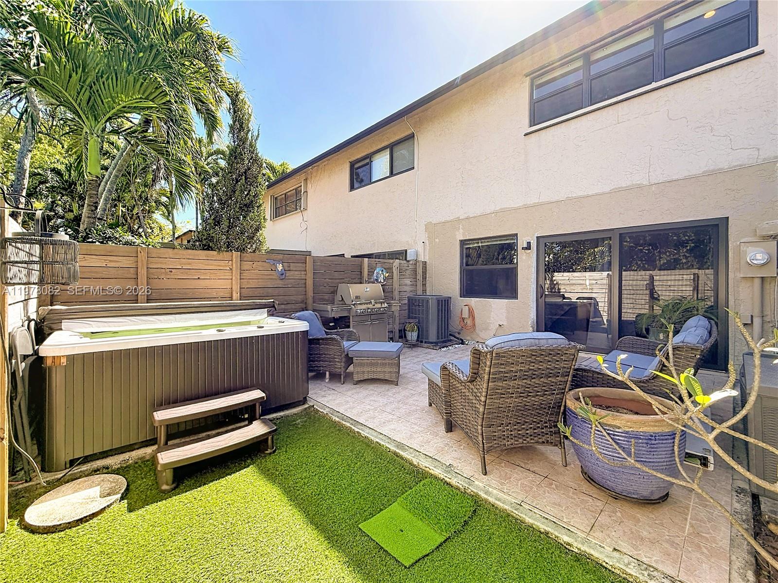 2128 Northeast 9th Avenue Wilton Manors, FL 33305 - Photo 32 of 34 a outdoor living space with furniture and a rug